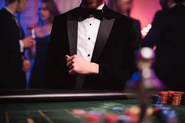 A young woman relaxing with her phone while dynamic casino elements float around her, illustrating the smooth mobile experience offered by the 26JL app.