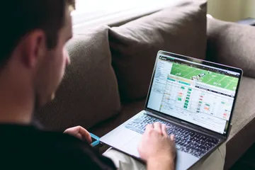 A cheerful woman in traditional clothing using her smartphone during a festive moment, showing how easily the 26JL app fits into everyday life.