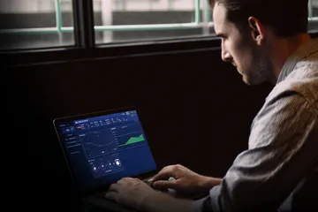 A woman smiling by bright slot machines showing lucky symbols, showcasing the exciting slot offerings at 26JL.